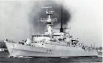 B&W photo of the destroyer, HMS Ambuscade, steaming out of a harbour