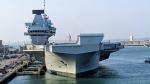 Royal Navy aircraft carrier, alongside in Portsmouth, viewed on a bright sunny day from the bow