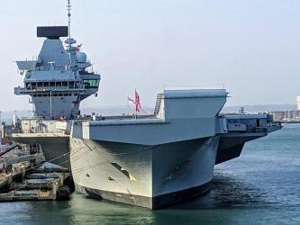 Royal Navy aircraft carrier, alongside in Portsmouth, viewed on a bright sunny day from the bow
