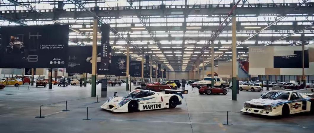 Classic cars laid out in a huge industrial space