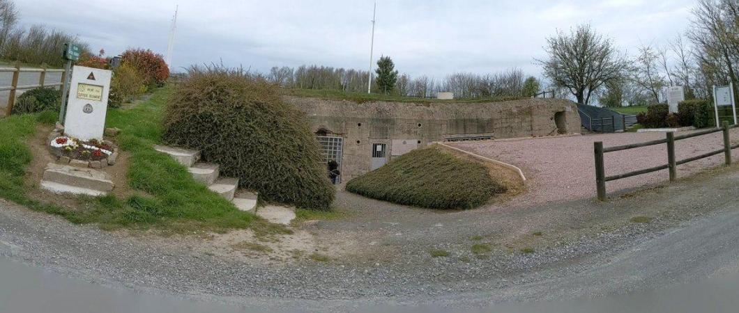 View of a partially hidden bunker with signage outside