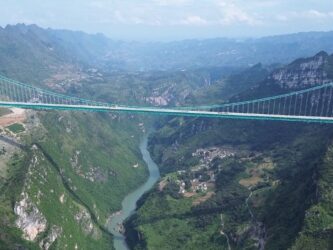 Aerial view of the huge Huajiang Grand Canyon suspension bridge and the valley below
