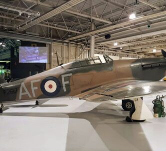 A brown & green camouflaged Hurricane fighter