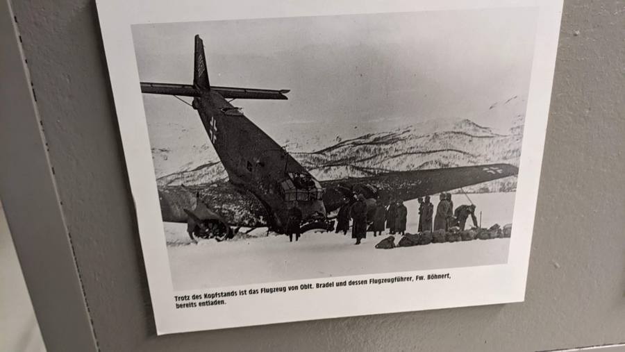 Black & white photo of a Junkers 52 tipped up on its nose on the frozen lake Hartvik