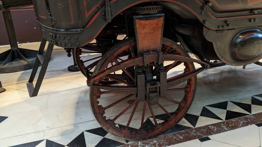 A close up of one wheel and its suspension