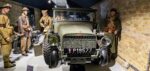 A group of Allied soldiers (mannequins) stand next to a Laffly v15T military truck