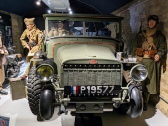 A group of Allied soldiers (mannequins) stand next to a Laffly v15T military truck