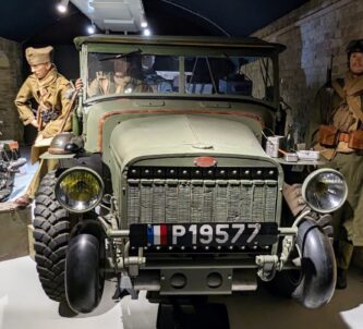 A group of Allied soldiers (mannequins) stand next to a Laffly v15T military truck