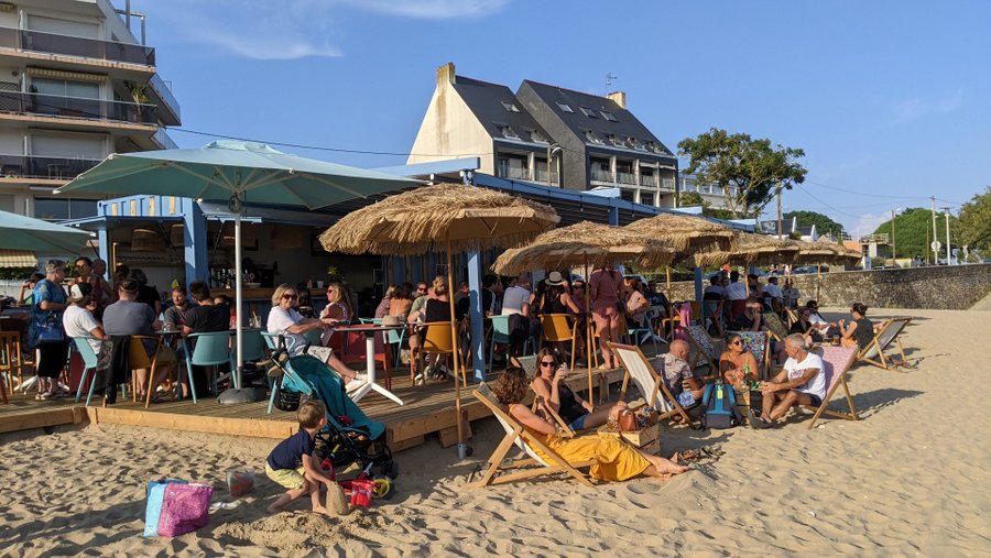 Crowded beach bar in evening sunshine