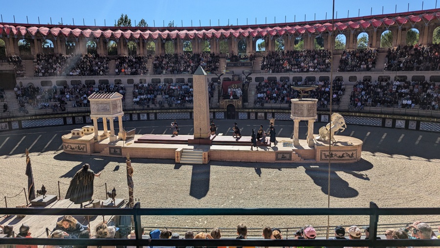 Roman amphitheatre with crowds beginning to fill it