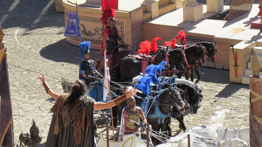 Four chariots line up ready to start the race