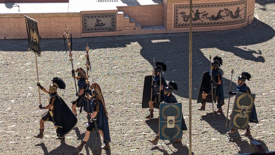 Roman legionnaires march around the amphitheatre floor