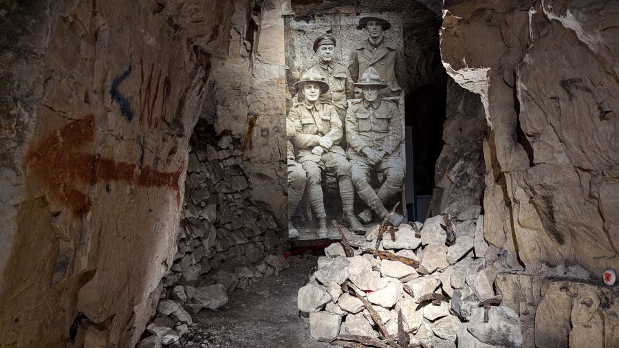 A large black and white image in an alcove shows a group of New Zealand miners sitting for a posed miners photo
