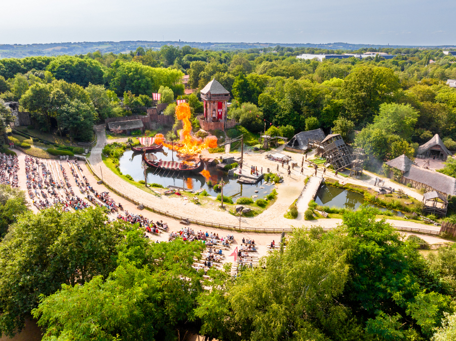 Aerial view. Flames erupt from a Viking longboat