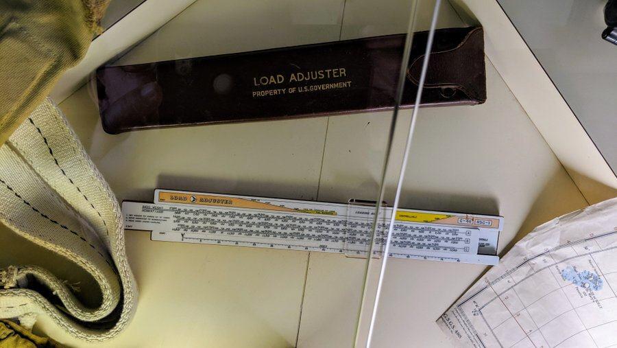 A slide rule and its case for calculating load displacement on a C-47