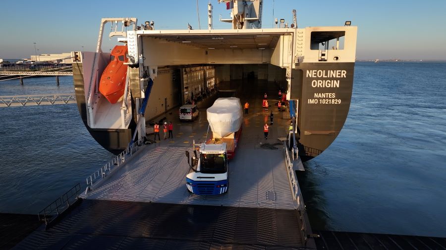 A tractor unit pushed a trailer with a yacht on it , up the ramp into Neoliner Origin's hold