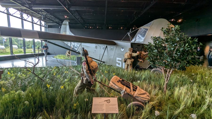 An infantryman (mannequin) pulls a handcart with supplies past the Waco glider
