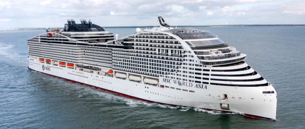 A large white MSC World class cruise ship at sea