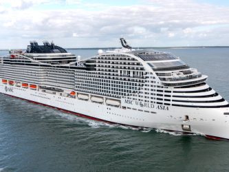 A large white MSC World class cruise ship at sea