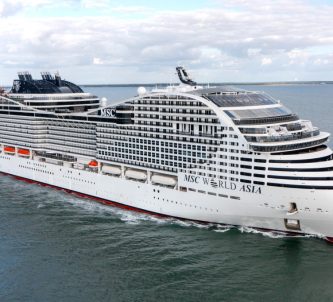 A large white MSC World class cruise ship at sea