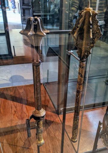 Two elaborate maces in a cabinet