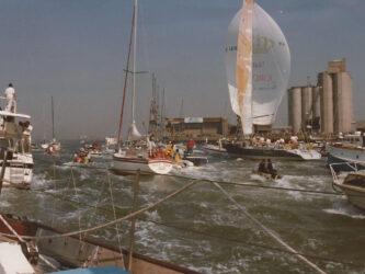 Tracey Edwards boat returning to Southhampton in 1973 and surrounded by a welcoming flotilla of small boats