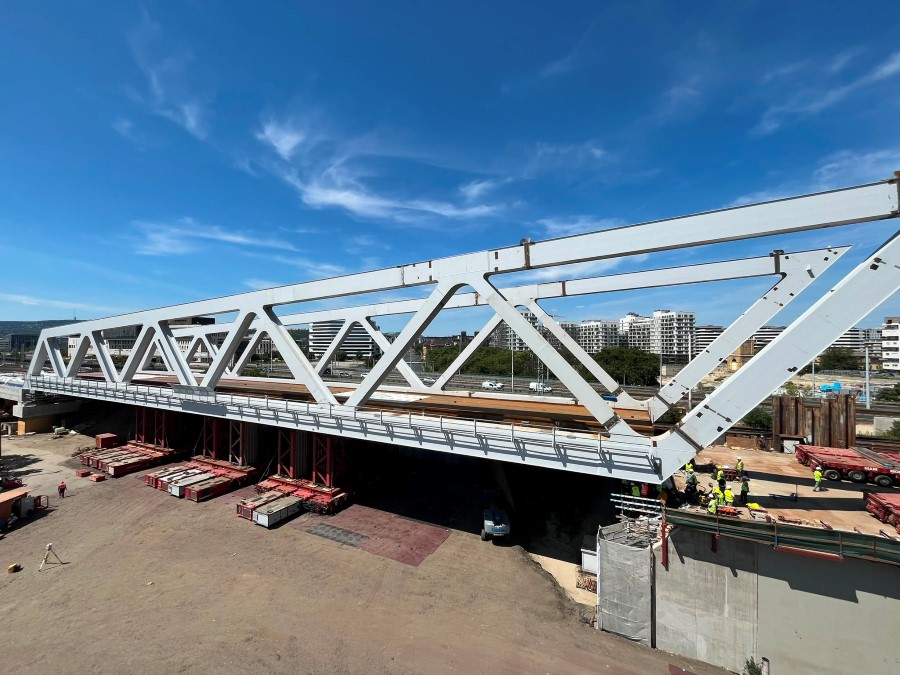 A large grey steel box girder bridge in place