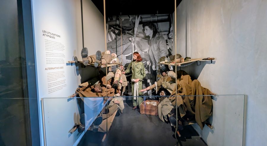 A nurse (mannequin) attends wounded soldiers on stretchers in the framework of a Waco glider