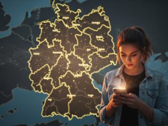Ai generated image. A young woman looks at her phone with a regional map of Germany as a background