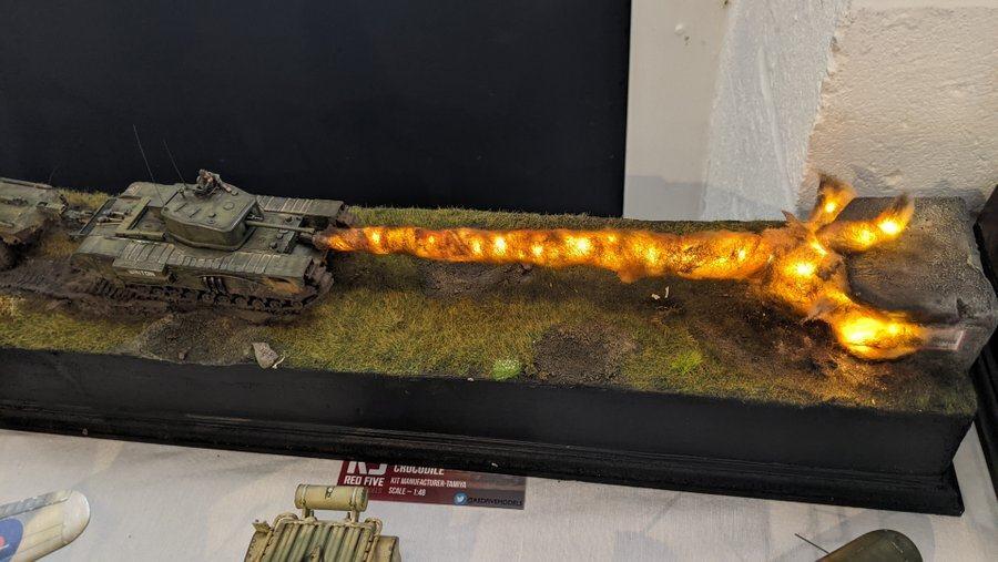 A model tank diorama with the tank hurling a fireball at a pillbox 
