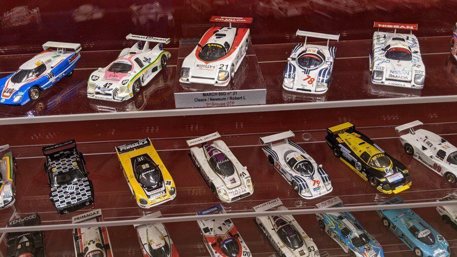Model cars on display in glass fronted cabinet