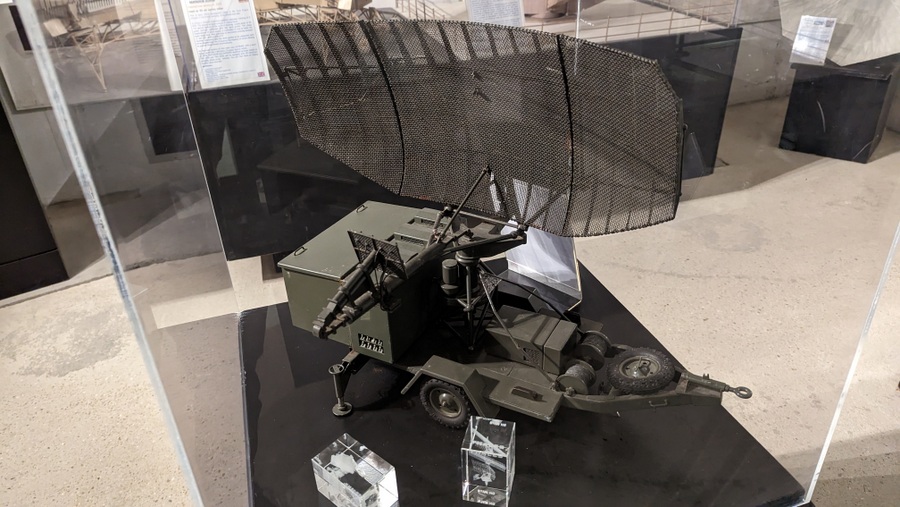 Scale model of a Cold War mobile radar unit in a glass display case