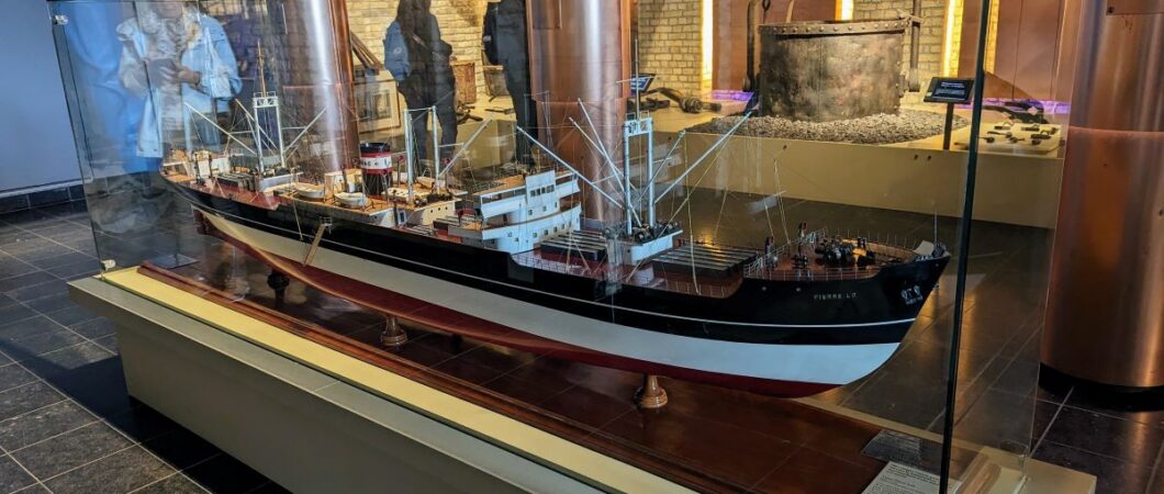 Large model of a 20th century cargo ship in a glass case