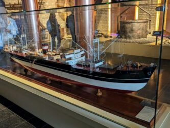 Large model of a 20th century cargo ship in a glass case