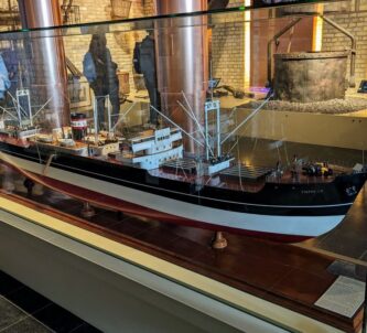 Large model of a 20th century cargo ship in a glass case