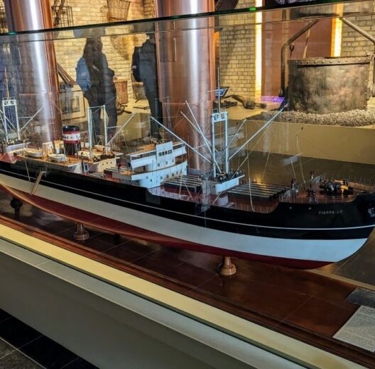 Large model of a 20th century cargo ship in a glass case