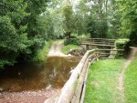 Close up image of Moissy Ford and the wooden pedestrian bridge over it.