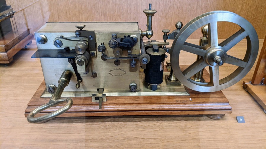 A lovely brass device with a big key for the clockwork and a reel for the paper roll which was fedd through the receiver/printer