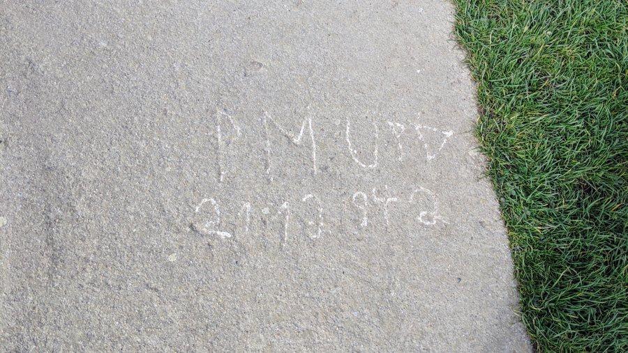 Name and date etched in concrete