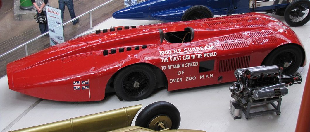 Three vintage racing cars on display