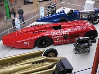 Three vintage racing cars on display