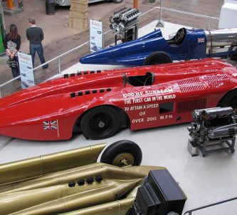 Three vintage racing cars on display