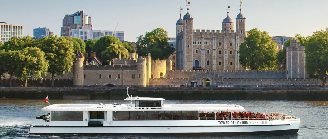 White Tower of London River Tour boat passes the Tower of London