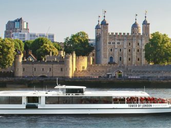 White Tower of London River Tour boat passes the Tower of London