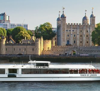 White Tower of London River Tour boat passes the Tower of London