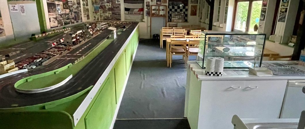 A Scalextric model race track dominates a large museum gallery