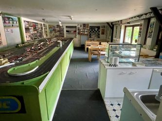 A Scalextric model race track dominates a large museum gallery