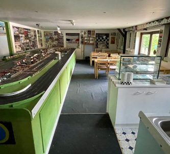 A Scalextric model race track dominates a large museum gallery