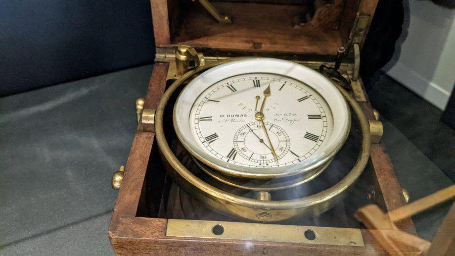 A gimbaled brass chronometer in a mahogany case