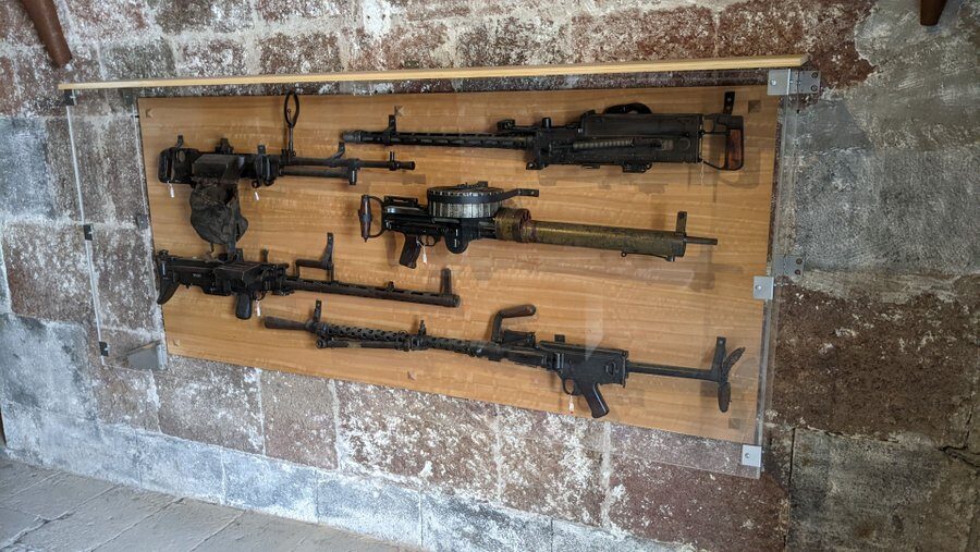 A collection of machine guns displayed on the wall